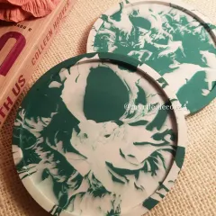A set of our round coasters in a striking green and white marble pattern. Each coaster is sealed to be water-resistant and backed with cork to protect your furniture.
