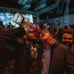 No one gets left behind in our parties. We believe in creating a shared experience, bringing guests together for fun moments like this, pouring drinks directly from the bottle.