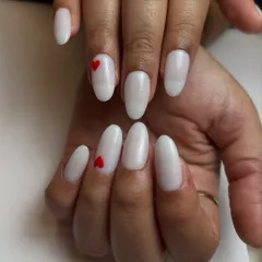 Why not romanticize everything? This sweet and simple design features a clean, milky white base with a tiny, perfectly placed red heart accent nail.