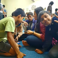 A child gives a happy wave during a library session. We are so grateful to be back in our libraries, sharing these moments of connection and bringing smiles back to life.
