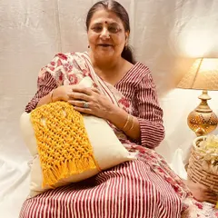 Here I am with one of my macrame cushion tie-backs. It’s a simple way to add a bit of texture and personality to a plain cushion. I love how this mustard yellow piece brings a pop of color and a cozy, handcrafted feel to the room.