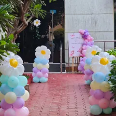 The entrance decor for the fairy garden party, featuring whimsical daisy balloon pillars that create a magical pathway for guests.