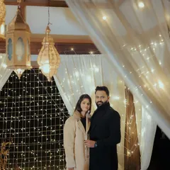 Another angle of the fairy light setup, showing the couple ready for a celebratory toast. The warm lights create a wonderfully romantic mood.