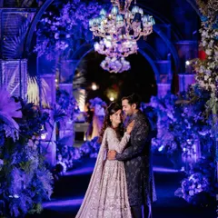 A love letter written in moonlight. For this Sangeet, we used dramatic blue uplighting, lush florals, and elegant chandeliers to create a romantic and poetic atmosphere for the couple's portraits.