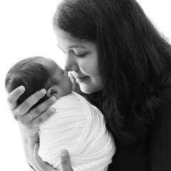 A tender black and white portrait of a mother holding her newborn baby, nose to nose. This image beautifully captures the immediate and deep connection between mother and child.