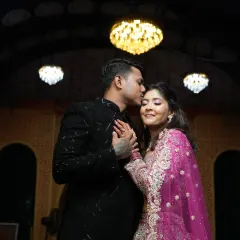 A romantic moment captured between the couple. Her makeup is flawless even in the low light, with a soft shimmer on the eyes and radiant skin.