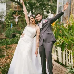 The triumphant exit from the church, arms raised in celebration. This photo captures the pure, uncontainable joy of a newly married couple, ready to start their life together.