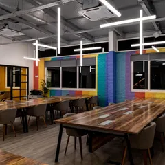 In this double-height workspace, I wanted to do more than just illuminate the room. I designed a sculptural installation with LED tube lights arranged in a dynamic pattern. This approach provides uniform, comfortable light across the desks while also acting as a unique piece of art that defines the brand's creative energy.