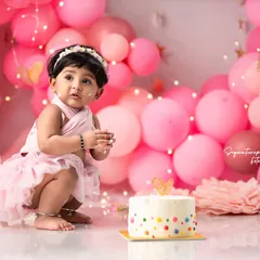 A first birthday deserves a grand celebration. This luxury cake smash session features a custom cake and an elaborate balloon wall, all designed around a soft pink theme. I handle all the props and decor, so you can simply enjoy watching your little one have a wonderfully messy time.