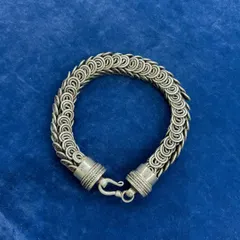 A full view of our unisex silver chainmail-style bracelet. The intricate, interlocking ring design gives it a substantial feel and a unique texture, making it a statement piece for anyone.
