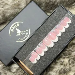 My classic French manicure press-on set in a sophisticated oval shape. The natural-looking pink base and crisp white tips provide a timeless and clean look that is perfect for any occasion.