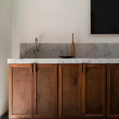 In Maison Rouge, we used reclaimed timber and local stone to create a rustic yet refined aesthetic. This simple wooden cabinet with a marble top exemplifies the project's balance of contemporary planning with traditional, vernacular materials.