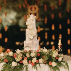 An elegant, modern wedding cake with a textured finish and beautiful white floral decorations. I work with the best bakers to create edible works of art.