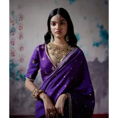 This traditional purple saree is elevated with intricate embroidery and styled with statement jewelry. It's a beautiful option for wedding guests or anyone attending a festive event who wants a look that feels special and culturally rich.