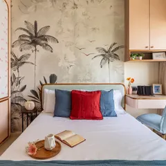 A bedroom is more than just a place to sleep. Here, a custom botanical wallpaper creates a stunning feature wall, while the integrated study nook and soft color palette combine beauty with practicality, even in a compact room.