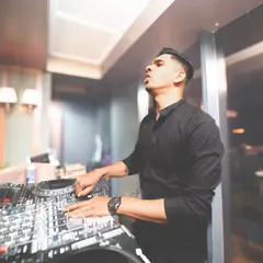 Focused on the mix, finessed in my craft. A shot of me locked into the music, preparing the next drop.