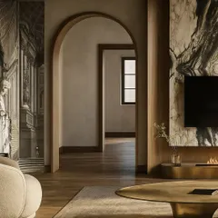 We love creating a journey through a home. This view shows how the arched doorway frames the next space, while a curved wall with mural wallpaper on the left adds an artistic layer, softening the room's edges.
