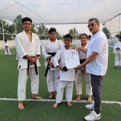 A proud moment as a student receives his official black belt (Shodan) certificate, sent all the way from the WSKF headquarters in Tokyo, Japan. This is the culmination of years of dedication.