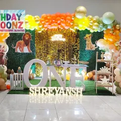 I designed this entire Lion King theme setup for a first birthday party. It features a lush green backdrop, a sparkling sequin panel, character cutouts of Simba and his friends, and large marquee letters spelling "ONE" to create a complete photo-ready stage.