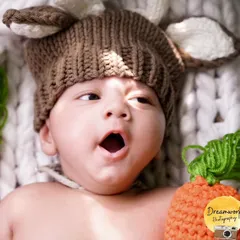 A big yawn from our little model. We work patiently to capture all the adorable, natural expressions of your newborn, from sleepy yawns to curious gazes.