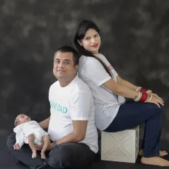 A relaxed and happy portrait of new parents with their newborn baby. We make sure to capture the whole family during our sessions.