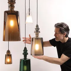 Designer Matteo Ugolini presenting his reimagined iconic lamp. The design enhances transparency and reflections, and is available in various colors and sizes to be clustered or used alone.