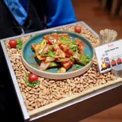 Our catering options include delicious appetizers for adult guests, like this beautifully presented Chilli Paneer Dry, ensuring everyone has something tasty to enjoy.