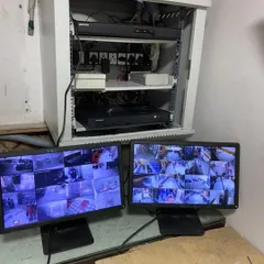A clean and organized security setup is crucial for reliability. This is the final monitoring station for a large commercial client, featuring a professionally organized server rack and a dual-monitor setup for comprehensive surveillance of the entire premises.