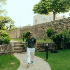 A full-length shot of me walking through a park in Delhi. This photo places the brand's apparel in an urban nature setting, highlighting its versatility for city dwellers who love the outdoors.