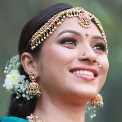 Capturing pure joy and laughter is always a goal. This candid shot from our bridal saree collaboration highlights the model's smile and the intricate details of her 'jhumka' earrings.