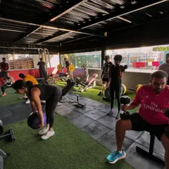 A wide shot of the gym floor, bustling with members working through different exercises. This captures the energy and community spirit of a typical session.