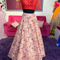 The full lehenga set on the mannequin, displaying the contrast between the red blouse and the floral A-line skirt.