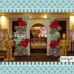 The royal entrance to Charvik's party. Guests were greeted by golden knight statues and a balloon arch in regal red, grey, and mint green.