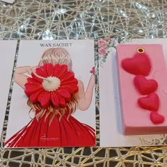 In addition to floral shapes, I also make other designs like this pink bar with small hearts. Next to it is a red flower sachet, showcasing the variety in my collection.