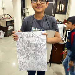 Proud artist Aman with his incredibly detailed tropical rainforest drawing. In our classes, we encourage kids to take on complex projects, guiding them through the process of planning and executing their vision.