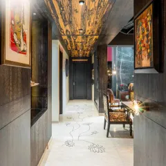 A corridor is more than just a passage. Here, we used a dramatic wood grain on the ceiling and a custom floral inlay in the marble floor to turn it into a work of art.