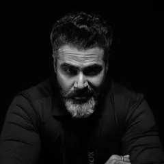 A direct and confident gaze. This black and white studio portrait is all about capturing a strong presence, with the lighting sculpted to define his features and create a timeless, masculine image.