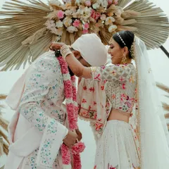 The beautiful Varmala or Jaimala ceremony, where the bride playfully places the garland on the groom. This candid shot captures a key ritual with a touch of fun and personality.