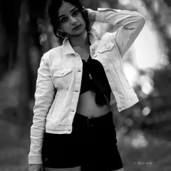 This black and white outdoor portrait has a classic, cinematic feel, with the focus on the subject's expression and pose.