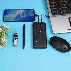 A flat-lay photograph of a tech-focused corporate gift set, including a power bank, USB drive, and mouse, arranged to show their use with a laptop and phone.