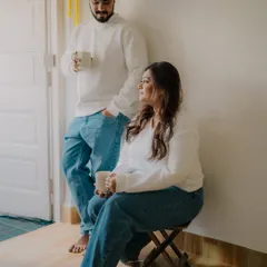 A quiet, candid moment of a couple enjoying coffee at home. This unposed shot captures the simple, everyday intimacy that is at the heart of a relationship.
