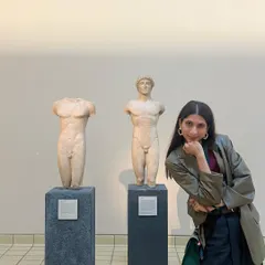 Posing with some classical statues at the museum. My outfit, with its structured blazer and relaxed pants, feels right at home among the art.