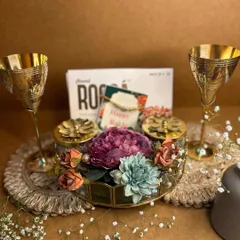 For a truly royal Rakhi affair, this vintage-style hamper features brass wine goblets, gourmet chocolates, and a floral-decorated box, making it a luxurious gift for a brother or a couple.