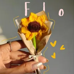 A close-up of the mini crochet sunflower, a perfect little burst of sunshine that you can hold in your hand.