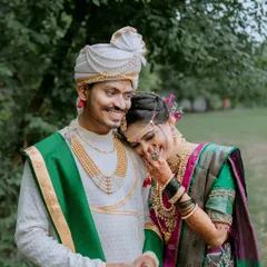 A candid and tender moment between a Maharashtrian couple. The bride's gentle lean and the groom's smile show their deep connection.