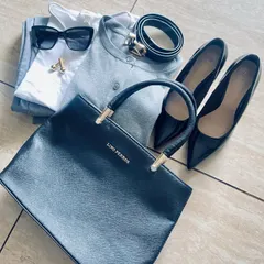 This flat lay shows how to elevate a monochrome grey and black outfit. By adding touches of gold through accessories like cufflinks and a belt buckle, and pairing with classic black pumps, the look becomes instantly more glamorous.