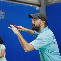 A player prepares to serve, his focus absolute. Our events allow employees to tap into their competitive side, a healthy outlet from the pressures of the office.