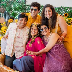The Haldi ceremony is all about joy and family. I styled the family in shades of yellow, pink, and purple, creating a vibrant and happy color palette that looks beautiful in photos. This candid group hug is pure happiness.