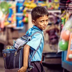 Capturing this schoolboy's portrait in a busy Hampi market was about freezing a single, genuine moment in time. This is what I love about street photography; it allows me to create candid child portraits that feel alive and full of personality.
