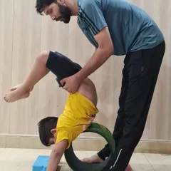 Safety and proper alignment are my top priorities in kids' yoga. Here, I am assisting one of our young yogis in a backbend using a yoga wheel, helping him build strength and flexibility in a controlled and supportive way.